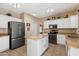 Modern kitchen with stainless steel appliances, granite countertops, and a central island at 25818 N 68Th Ave, Peoria, AZ 85383