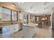 Well-lit kitchen flowing to dining area featuring granite countertops and stainless steel appliances at 25818 N 68Th Ave, Peoria, AZ 85383