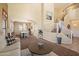 Bright living room with stairs, dining area, and neutral decor creating a welcoming space at 25818 N 68Th Ave, Peoria, AZ 85383