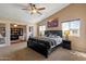 This main bedroom has a ceiling fan, desert wall art, and lots of natural lighting at 25818 N 68Th Ave, Peoria, AZ 85383