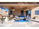 A covered patio has two ceiling fans, lounge furniture, a bar, and barstools at 25818 N 68Th Ave, Peoria, AZ 85383
