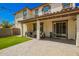 Charming covered backyard patio area with brickwork, grass and string lights at 263 N Wilson Dr, Chandler, AZ 85225