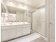 Bathroom featuring dual sinks, large mirror, and a shower with glass doors at 263 N Wilson Dr, Chandler, AZ 85225