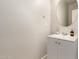 Bathroom featuring a round mirror, white vanity, and modern fixtures at 263 N Wilson Dr, Chandler, AZ 85225