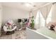 Charming bedroom with ample lighting, plush chair, and a comfy gaming setup at 263 N Wilson Dr, Chandler, AZ 85225