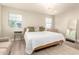 Bright bedroom with wood-look floors, large windows and a modern chandelier at 263 N Wilson Dr, Chandler, AZ 85225