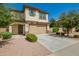 Inviting two-story home showcasing desert landscaping, covered porch, and a two-car garage at 263 N Wilson Dr, Chandler, AZ 85225