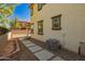 Side view of property with stepping stones, AC unit, and iron fence at 263 N Wilson Dr, Chandler, AZ 85225