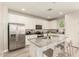 Modern kitchen featuring white cabinets, granite countertops, and stainless steel appliances at 263 N Wilson Dr, Chandler, AZ 85225