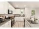 Updated kitchen with granite countertops, stainless steel appliances, and light wood-look flooring at 263 N Wilson Dr, Chandler, AZ 85225