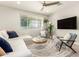 Bright living room with stylish furniture, ceiling fan, and large window at 263 N Wilson Dr, Chandler, AZ 85225