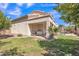 Rear exterior of home with covered patio looking out to a well-maintained lawn and mature landscaping at 2642 S Joplin --, Mesa, AZ 85209