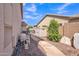 Side yard featuring gravel, a storage shed, and mature landscaping for easy outdoor maintenance at 2642 S Joplin --, Mesa, AZ 85209