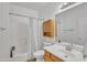 Bright bathroom featuring a tub, shower with curtain, single vanity and light fixtures at 2642 S Joplin --, Mesa, AZ 85209