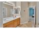 Bright bathroom featuring a double sink vanity, neutral walls, and an open doorway to a bedroom at 2642 S Joplin --, Mesa, AZ 85209