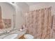 Cozy bathroom featuring a granite countertop vanity and shower with a decorative shower curtain at 2642 S Joplin --, Mesa, AZ 85209