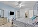 Bedroom with a light blue accent wall includes a tv, ceiling fan and a cozy queen-size bed at 2642 S Joplin --, Mesa, AZ 85209