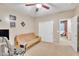 Cozy bedroom with ceiling fan, light tan carpet, a futon, and film noir-themed wall decor at 2642 S Joplin --, Mesa, AZ 85209
