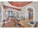 Formal dining room with wood floors, a large table with seating for eight, and decorative ceiling accents at 2642 S Joplin --, Mesa, AZ 85209