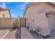Tan home exterior featuring a stone walkway leading to a secure gate, and a gravel landscape at 2642 S Joplin --, Mesa, AZ 85209