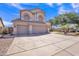 Charming two-story home with a three-car garage, paved driveway, and low-maintenance desert landscaping in a sunny setting at 2642 S Joplin --, Mesa, AZ 85209