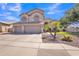 Charming two-story home with a three-car garage, paved driveway, and low-maintenance desert landscaping at 2642 S Joplin --, Mesa, AZ 85209
