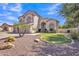 Stunning two-story home boasts arched windows, a three-car garage, and lush landscaping with palm trees and desert plants at 2642 S Joplin --, Mesa, AZ 85209