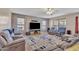 Comfortable living room with plush seating, ceiling fan, and large windows providing natural light at 2642 S Joplin --, Mesa, AZ 85209