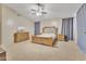 Bright main bedroom featuring a ceiling fan, carpeted floors, neutral walls, and furnishings for a calm, relaxing ambiance at 2642 S Joplin --, Mesa, AZ 85209