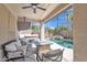 Inviting covered patio with ceiling fan, tv, and comfortable seating overlooking the sparkling pool and spa at 2642 S Joplin --, Mesa, AZ 85209