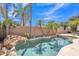 Beautiful pool with rock waterfall feature and mature palm trees, providing a private backyard oasis at 2642 S Joplin --, Mesa, AZ 85209