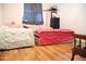 Bedroom with wood floors, two beds, and blue curtains at 2718 W Montebello Ave, Phoenix, AZ 85017