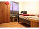 Cozy bedroom with wood floors and wardrobe, offering a tranquil retreat at 2718 W Montebello Ave, Phoenix, AZ 85017