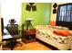 Comfortable bedroom featuring wood floors, desk, and a bright accent wall at 2718 W Montebello Ave, Phoenix, AZ 85017