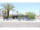 Charming single-story home featuring desert landscaping, a palm tree, and solar panels at 2718 W Montebello Ave, Phoenix, AZ 85017