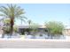 Charming single-story home featuring desert landscaping, a palm tree, and solar panels at 2718 W Montebello Ave, Phoenix, AZ 85017