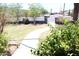 Lush front yard with mature landscaping and a walkway leading towards the street at 2718 W Montebello Ave, Phoenix, AZ 85017