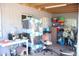 View of a cluttered garage interior showing storage shelves and miscellaneous items at 2718 W Montebello Ave, Phoenix, AZ 85017