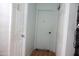 A clean hallway featuring multiple white doors and light-colored walls and hardwood floors at 2718 W Montebello Ave, Phoenix, AZ 85017