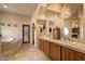 Bathroom with tub, double sinks, vanity and granite countertops at 27203 N 64Th Way, Scottsdale, AZ 85266