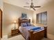 Comfortable bedroom with a wooden bed frame, neutral colors, and a ceiling fan at 27203 N 64Th Way, Scottsdale, AZ 85266