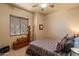 Bedroom with dresser and large window with window blinds at 27203 N 64Th Way, Scottsdale, AZ 85266