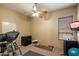 Functional exercise room featuring workout equipment, a ceiling fan, and natural light at 27203 N 64Th Way, Scottsdale, AZ 85266