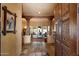 Grand foyer featuring slate floors, decorative wooden columns, and a glimpse of the living spaces at 27203 N 64Th Way, Scottsdale, AZ 85266