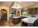 Spacious kitchen featuring stone tile flooring, a central island, and ample counter space for cooking at 27203 N 64Th Way, Scottsdale, AZ 85266