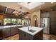 Island kitchen with stainless steel refrigerator and view of the connected living room and dining area at 27203 N 64Th Way, Scottsdale, AZ 85266