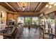 Living room with fireplace, leather sofa, wood beam ceiling, and views of outdoor patio at 27203 N 64Th Way, Scottsdale, AZ 85266