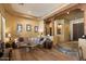 Cozy living room featuring warm tones, wood beam accents, and steps leading to another living space at 27203 N 64Th Way, Scottsdale, AZ 85266