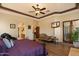 Comfortable main bedroom suite with ceiling fan, TV and access to an outdoor patio at 27203 N 64Th Way, Scottsdale, AZ 85266