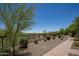 Spacious backyard with low-maintenance desert landscaping, bordered by an iron fence for privacy and security at 29431 N 122Nd Gln, Peoria, AZ 85383